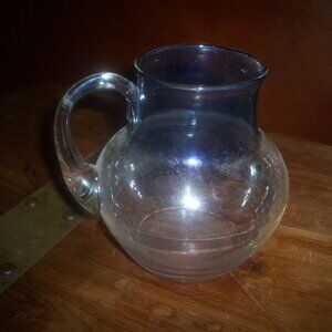 Clear Hand Blown Glass Pitcher With Blue Iridescent Rim And Attached Handle 5"